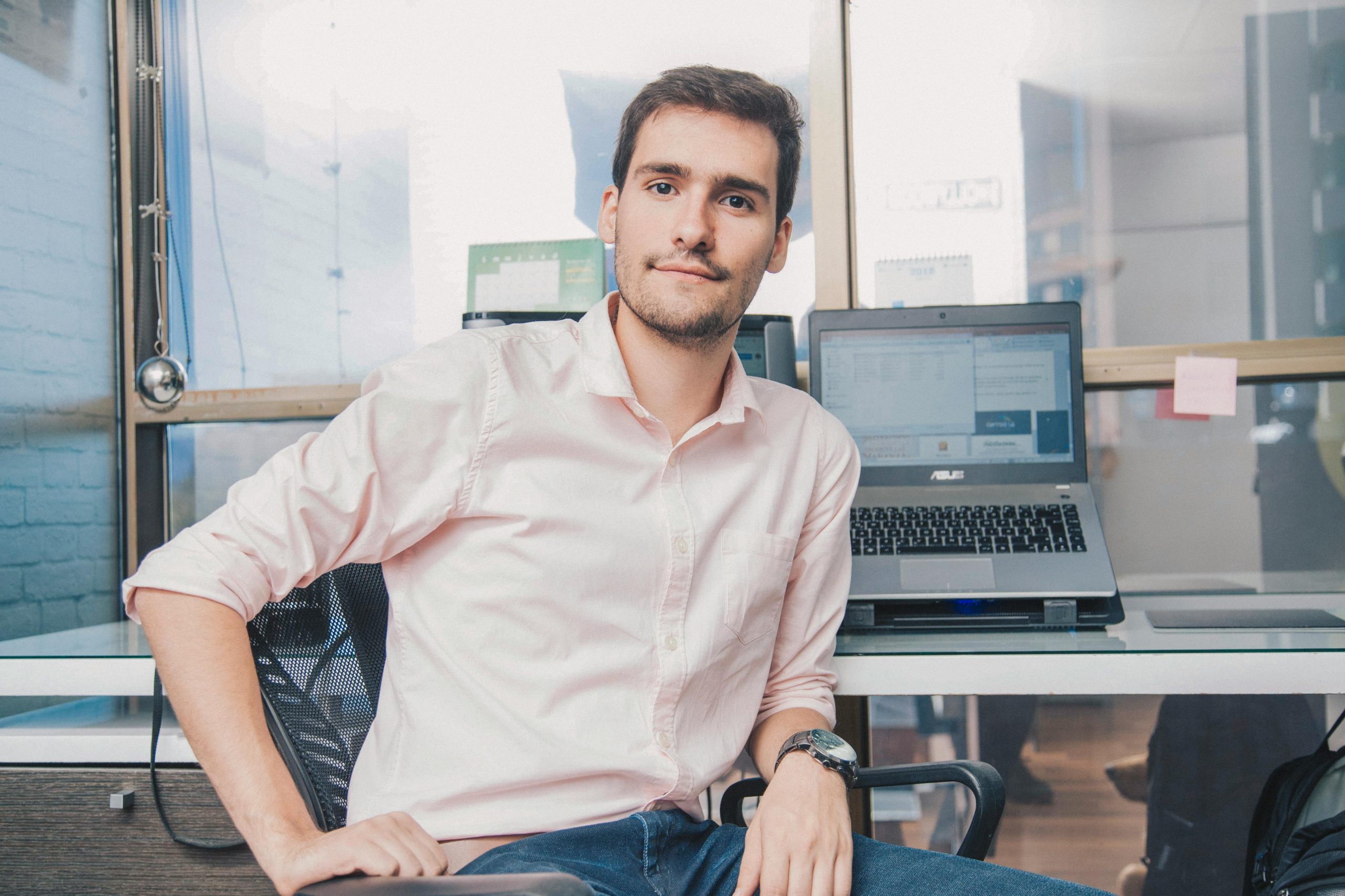 pexels-photo-7752893-7752893 Confident young man in shirt working in modern office with laptop and desk accessories.